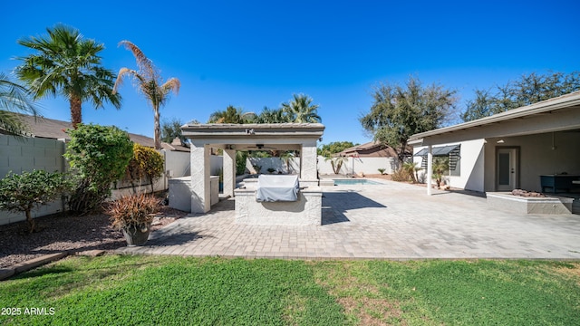 view of patio with a ceiling fan, a fenced in pool, and a fenced backyard