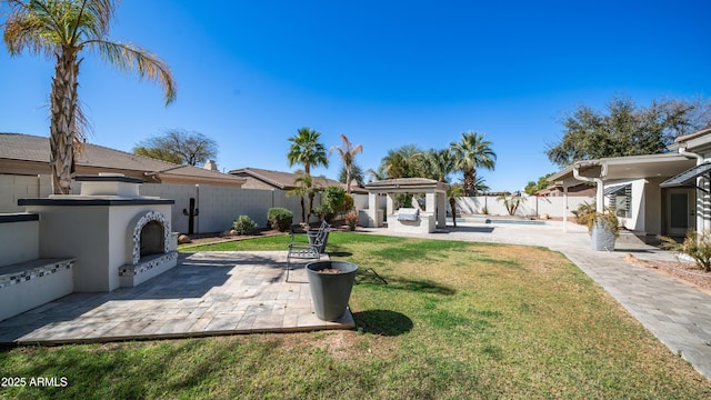 view of yard featuring a fenced in pool, a patio area, a fenced backyard, and a gazebo