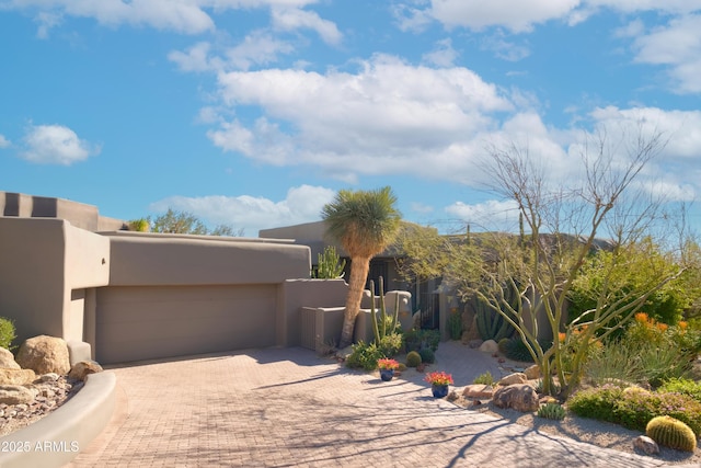 pueblo-style house featuring a garage