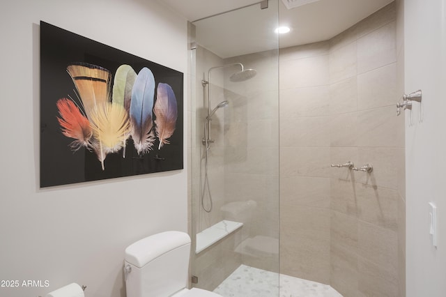 bathroom with toilet and tiled shower