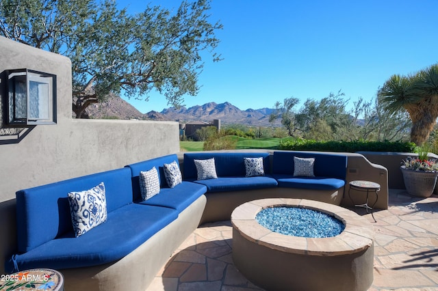 view of patio with an outdoor living space and a mountain view