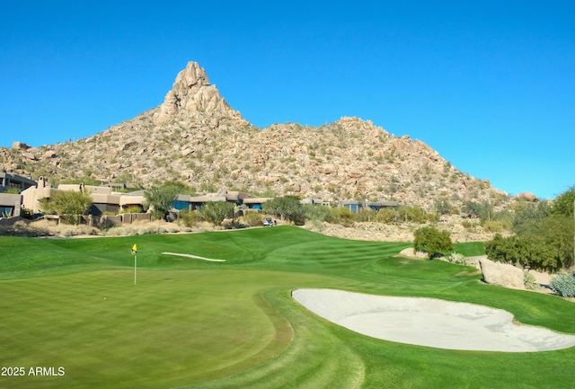 view of home's community featuring a lawn and a mountain view