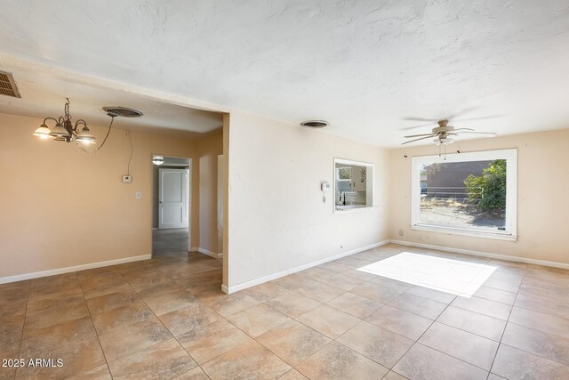 unfurnished room featuring light tile patterned flooring and ceiling fan with notable chandelier