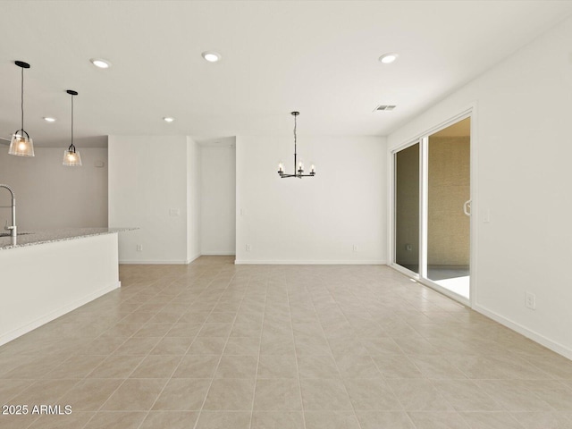 empty room with baseboards, visible vents, a notable chandelier, and recessed lighting