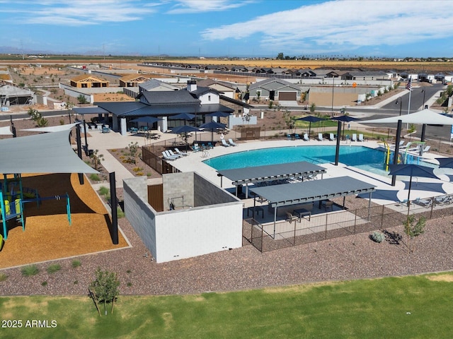 view of swimming pool with playground community and a residential view