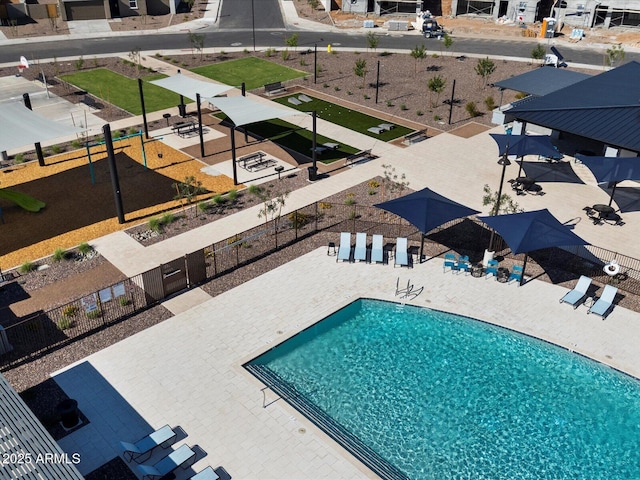 pool with a patio area and fence