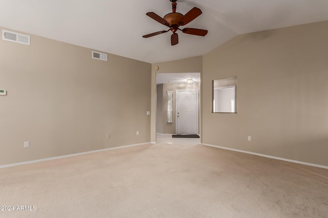 unfurnished room with lofted ceiling, light carpet, and ceiling fan