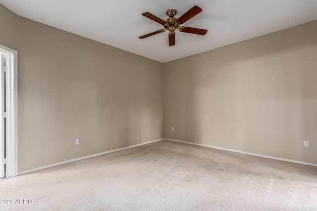 spare room featuring ceiling fan and light carpet