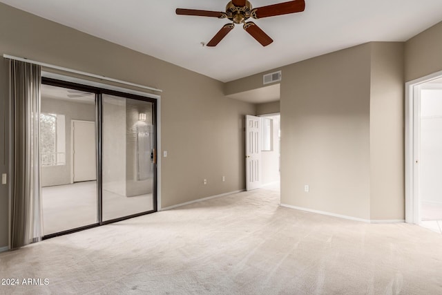 interior space featuring light colored carpet and ceiling fan