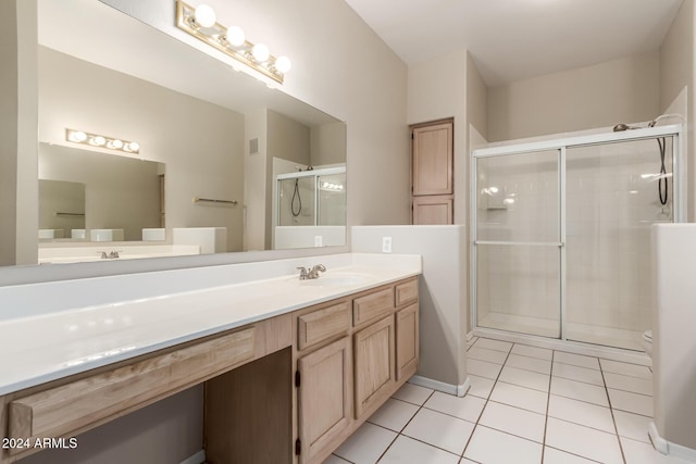 bathroom featuring vanity, tile patterned floors, and walk in shower