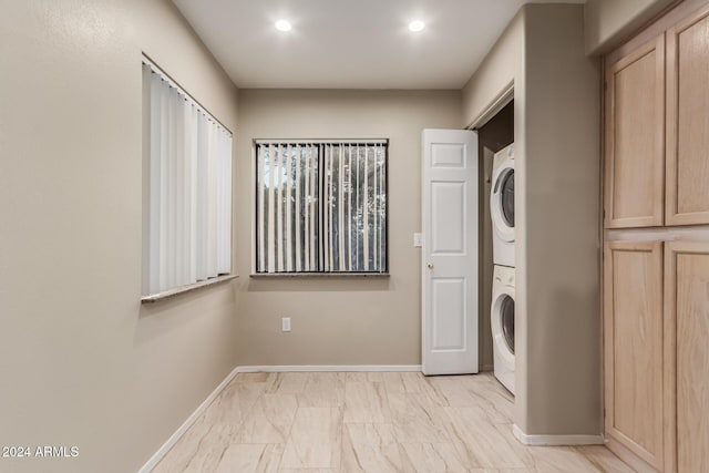 washroom with stacked washer / dryer