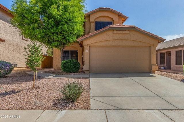 21621 N 48th Pl, Phoenix, AZ 85054 - mediterranean / spanish home featuring an attached garage, stucco siding, concrete driveway, and a tile roof