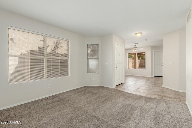 21621 N 48th Pl, Phoenix, AZ 85054 - tiled spare room with baseboards, carpet flooring, and ceiling fan