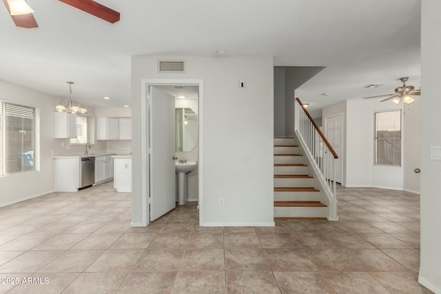 21621 N 48th Pl, Phoenix, AZ 85054 - unfurnished living room with ceiling fan with notable chandelier, baseboards, light tile patterned floors, visible vents, and stairway