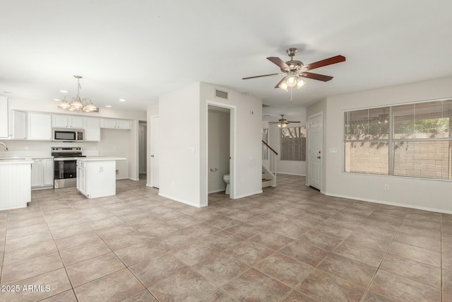 21621 N 48th Pl, Phoenix, AZ 85054 - unfurnished living room with visible vents, stairway, baseboards, ceiling fan with notable chandelier, and recessed lighting