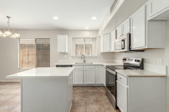 21621 N 48th Pl, Phoenix, AZ 85054 - kitchen with visible vents, appliances with stainless steel finishes, a center island, a sink, and white cabinets