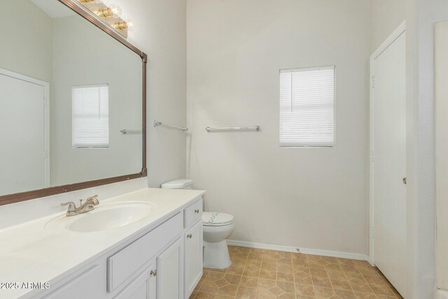21621 N 48th Pl, Phoenix, AZ 85054 - bathroom with vanity, baseboards, and toilet