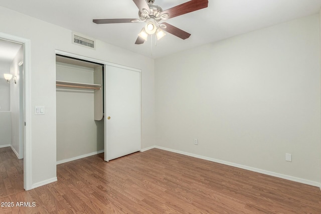 21621 N 48th Pl, Phoenix, AZ 85054 - unfurnished bedroom with ceiling fan, visible vents, baseboards, a closet, and light wood-style flooring