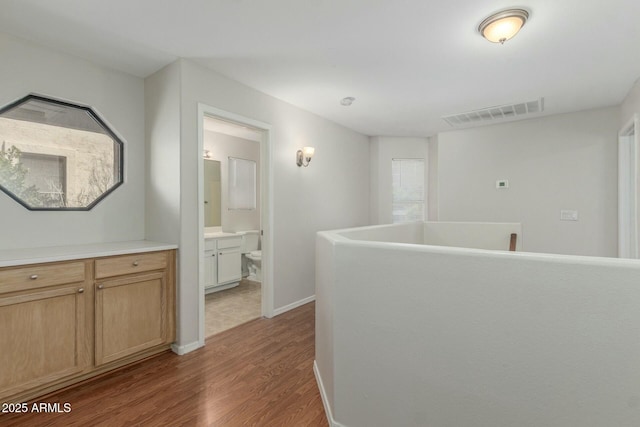 21621 N 48th Pl, Phoenix, AZ 85054 - corridor featuring baseboards, wood finished floors, and visible vents