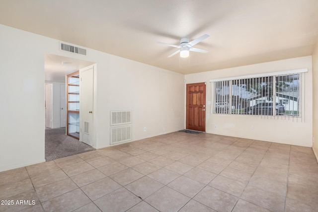 unfurnished room with ceiling fan, light tile patterned floors, and visible vents