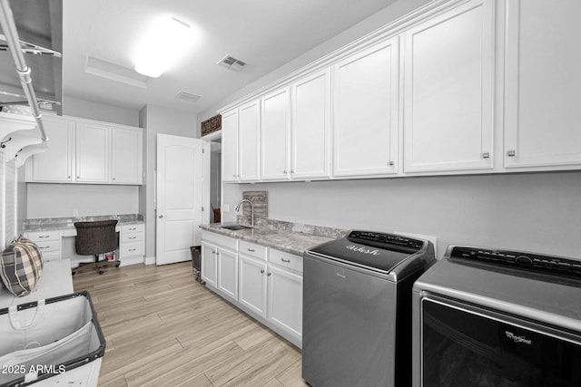 1167 E Knightsbridge Way, Gilbert, AZ 85297 - laundry room with independent washer and dryer, cabinet space, a sink, light wood-style flooring, and visible vents