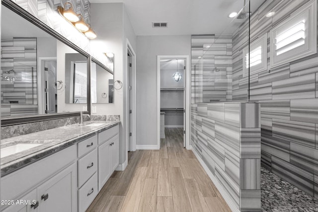 1167 E Knightsbridge Way, Gilbert, AZ 85297 - full bathroom with a sink, double vanity, tiled shower, and visible vents