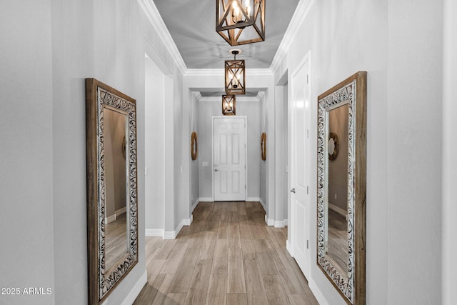 1167 E Knightsbridge Way, Gilbert, AZ 85297 - corridor featuring an inviting chandelier, baseboards, crown molding, and light wood-style flooring
