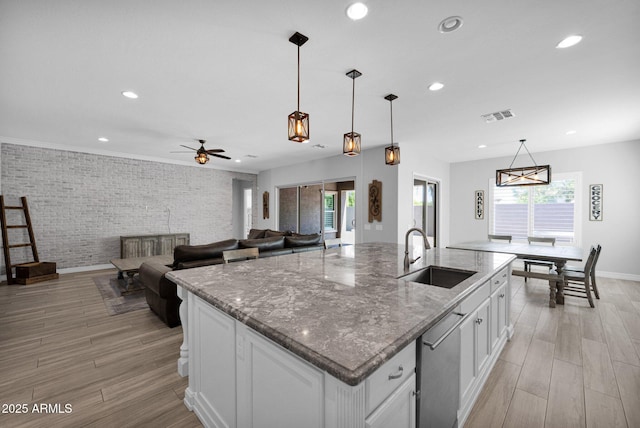 1167 E Knightsbridge Way, Gilbert, AZ 85297 - kitchen featuring a sink, recessed lighting, brick wall, and visible vents
