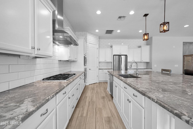 1167 E Knightsbridge Way, Gilbert, AZ 85297 - kitchen featuring white cabinets, a sink, wall chimney exhaust hood, stainless steel appliances, and visible vents