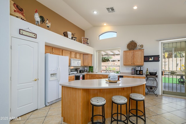 kitchen featuring a sink, light tile patterned floors, white appliances, and light countertops