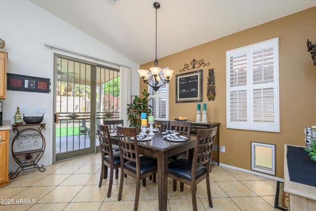 dining area with an inviting chandelier, light tile patterned flooring, and lofted ceiling
