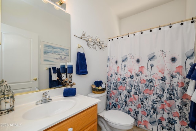 bathroom featuring vanity, a shower with shower curtain, and toilet