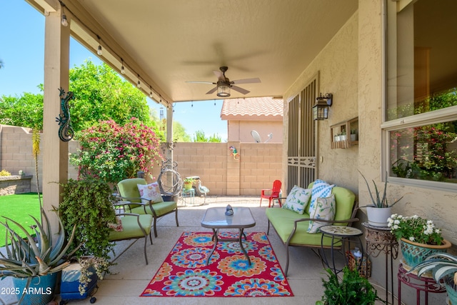 view of patio / terrace with a ceiling fan, fence, and an outdoor hangout area
