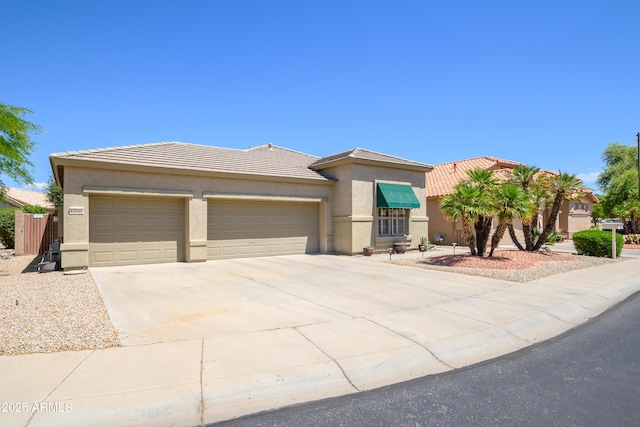 prairie-style house with a garage, stucco siding, a tiled roof, and driveway