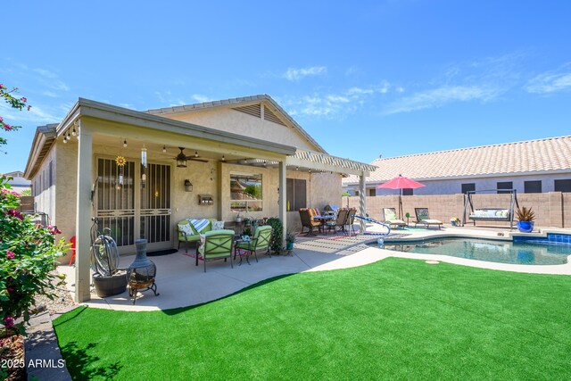 rear view of house featuring a lawn, a fenced in pool, a fenced backyard, a pergola, and stucco siding