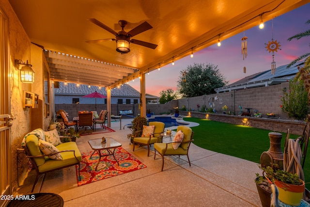 patio terrace at dusk with ceiling fan, outdoor lounge area, outdoor dining area, a fenced backyard, and a lawn