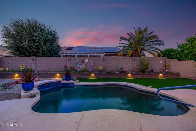 pool at dusk with a fenced in pool and a fenced backyard