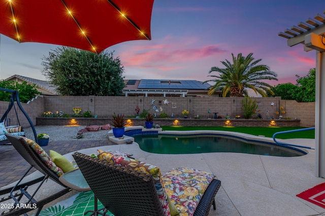 pool at dusk featuring a patio, a fenced in pool, and a fenced backyard