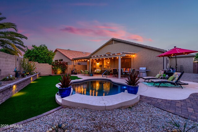 view of swimming pool with a pergola, a fenced backyard, a fenced in pool, a patio area, and a lawn