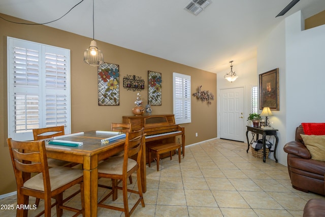 dining room with light tile patterned floors, baseboards, and visible vents