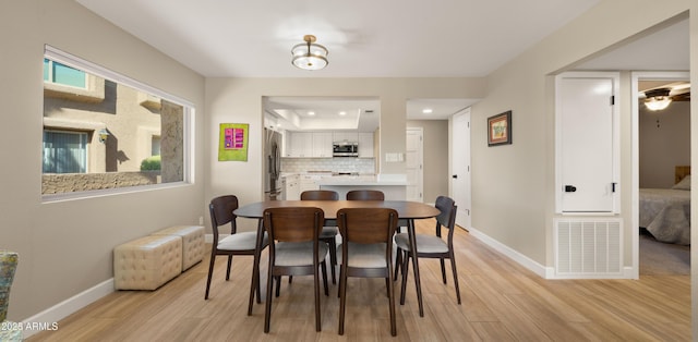 7424 N Via Camello Del Norte Unit 185, Scottsdale, AZ 85258 - dining area featuring light wood-style floors, baseboards, recessed lighting, and a raised ceiling