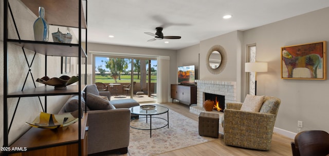 7424 N Via Camello Del Norte Unit 185, Scottsdale, AZ 85258 - living area featuring wood finished floors, ceiling fan, a brick fireplace, baseboards, and recessed lighting