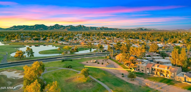 7424 N Via Camello Del Norte Unit 185, Scottsdale, AZ 85258 - aerial view at dusk of a water and mountain view, a residential view, and view of golf course