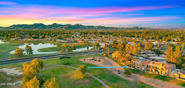 7424 N Via Camello Del Norte Unit 185, Scottsdale, AZ 85258 - aerial view at dusk of a water and mountain view, a residential view, and view of golf course