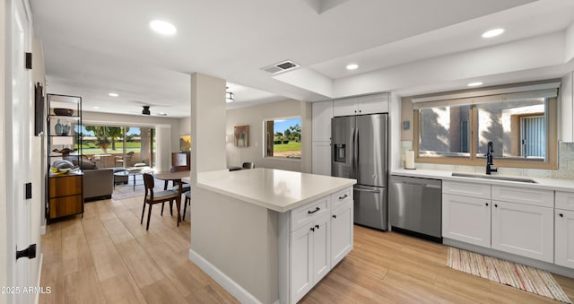 7424 N Via Camello Del Norte Unit 185, Scottsdale, AZ 85258 - kitchen featuring appliances with stainless steel finishes, a sink, light countertops, open floor plan, and recessed lighting