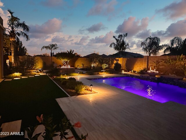 2308 E Dry Wood Rd, Phoenix, AZ 85024 - pool at dusk with a patio and a fenced backyard