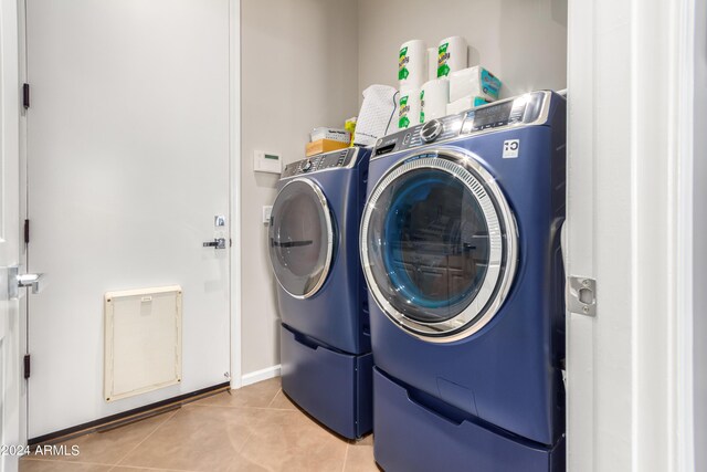2308 E Dry Wood Rd, Phoenix, AZ 85024 - laundry area featuring separate washer and dryer, light tile patterned flooring, and baseboards