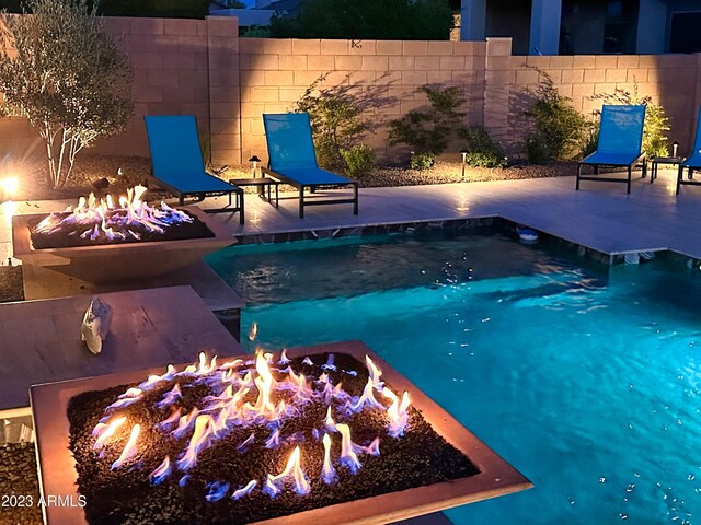 2308 E Dry Wood Rd, Phoenix, AZ 85024 - view of swimming pool featuring an outdoor fire pit, fence, and a patio area