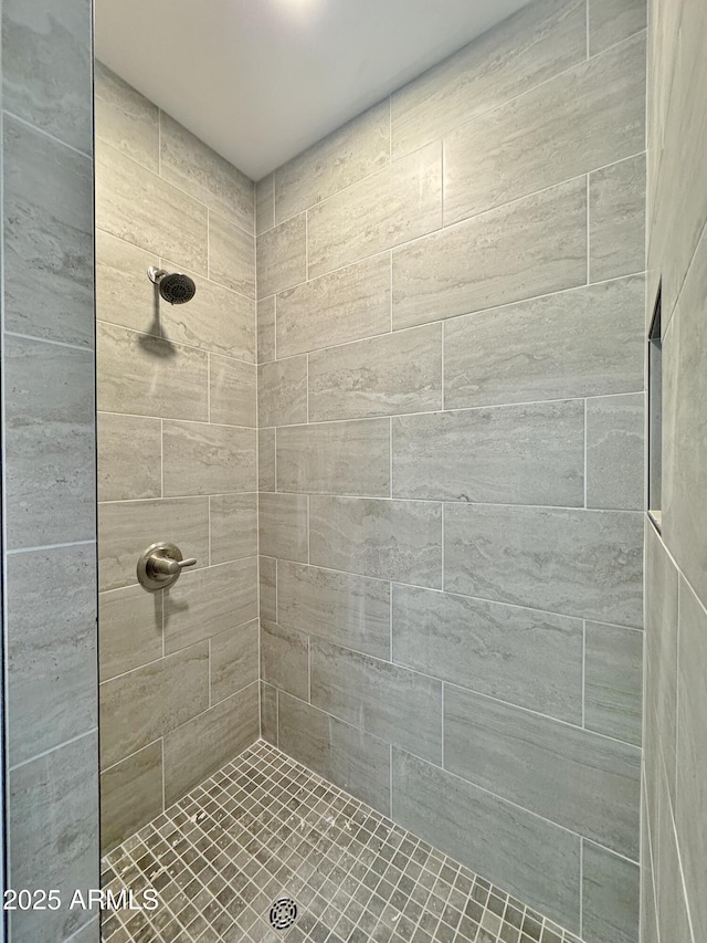 full bath featuring tiled shower