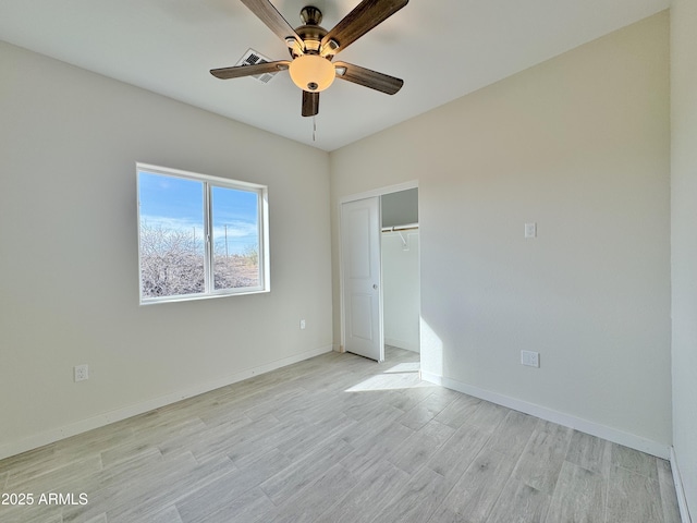 unfurnished bedroom with light wood-type flooring, baseboards, a closet, and ceiling fan